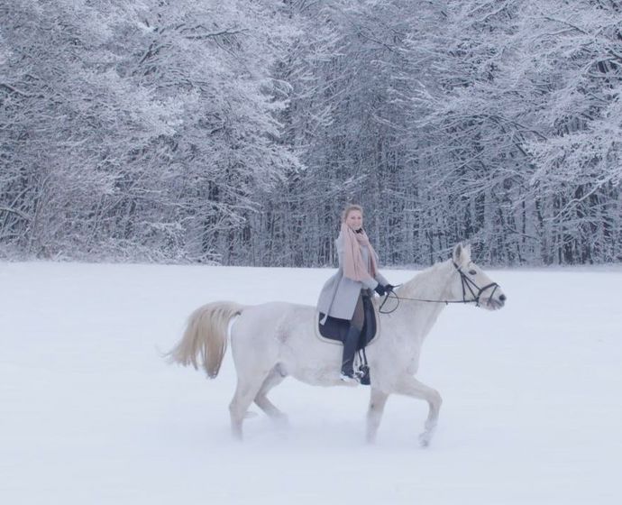 female rider on white horse